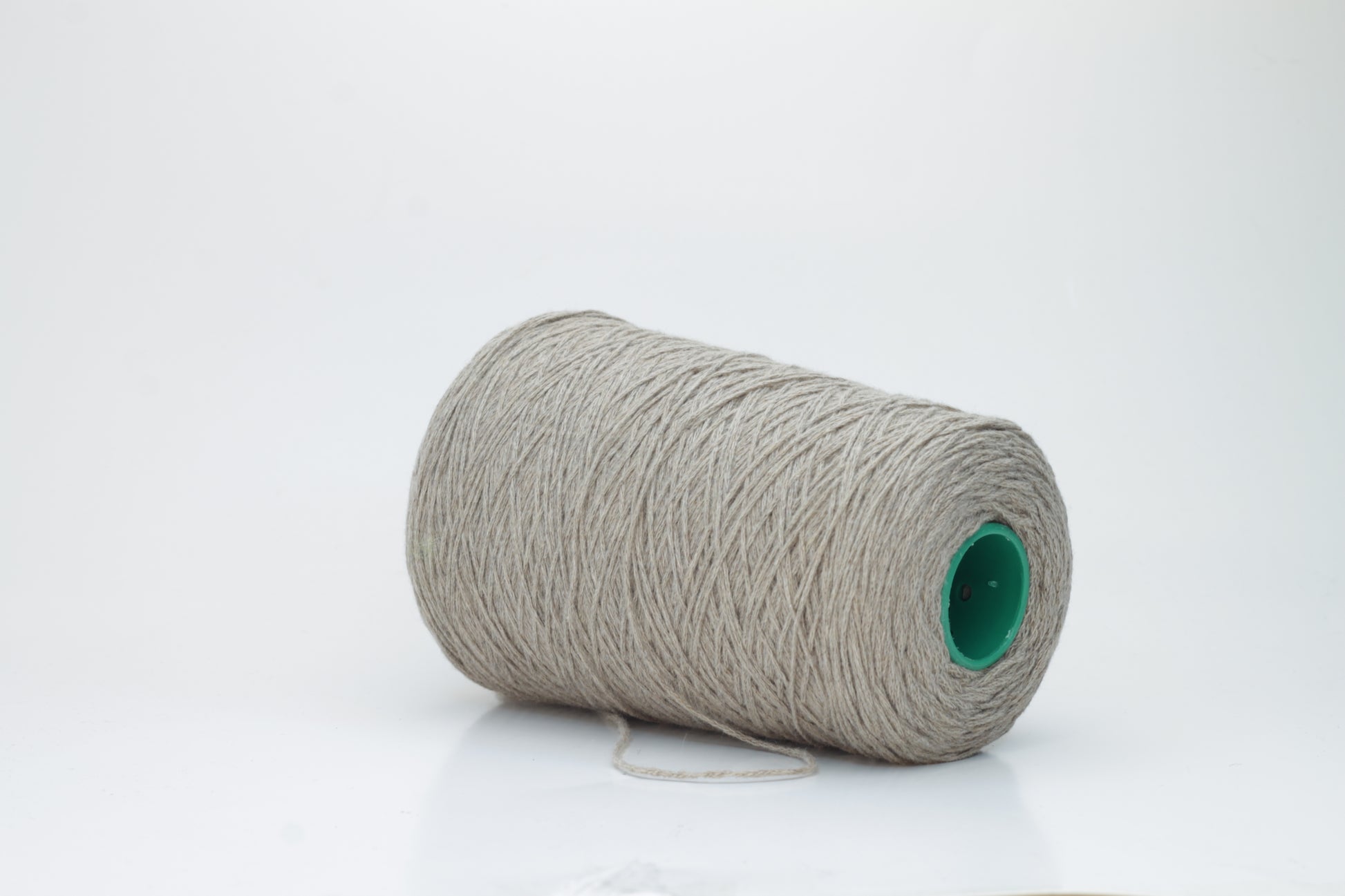 A finely spun, single-ply cashmere yarn in a rich, warm squirrel-brown, exhibiting a delicate halo of soft fibers and a subtle, natural sheen.