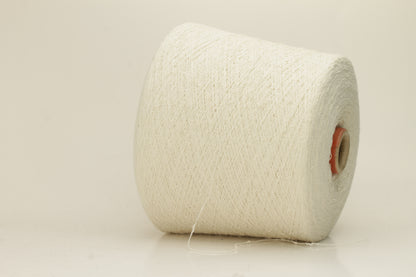 Close-up of a pure white, textured Nodino yarn, showing subtle, irregular nubs and a soft, matte sheen; twisted ply visible.