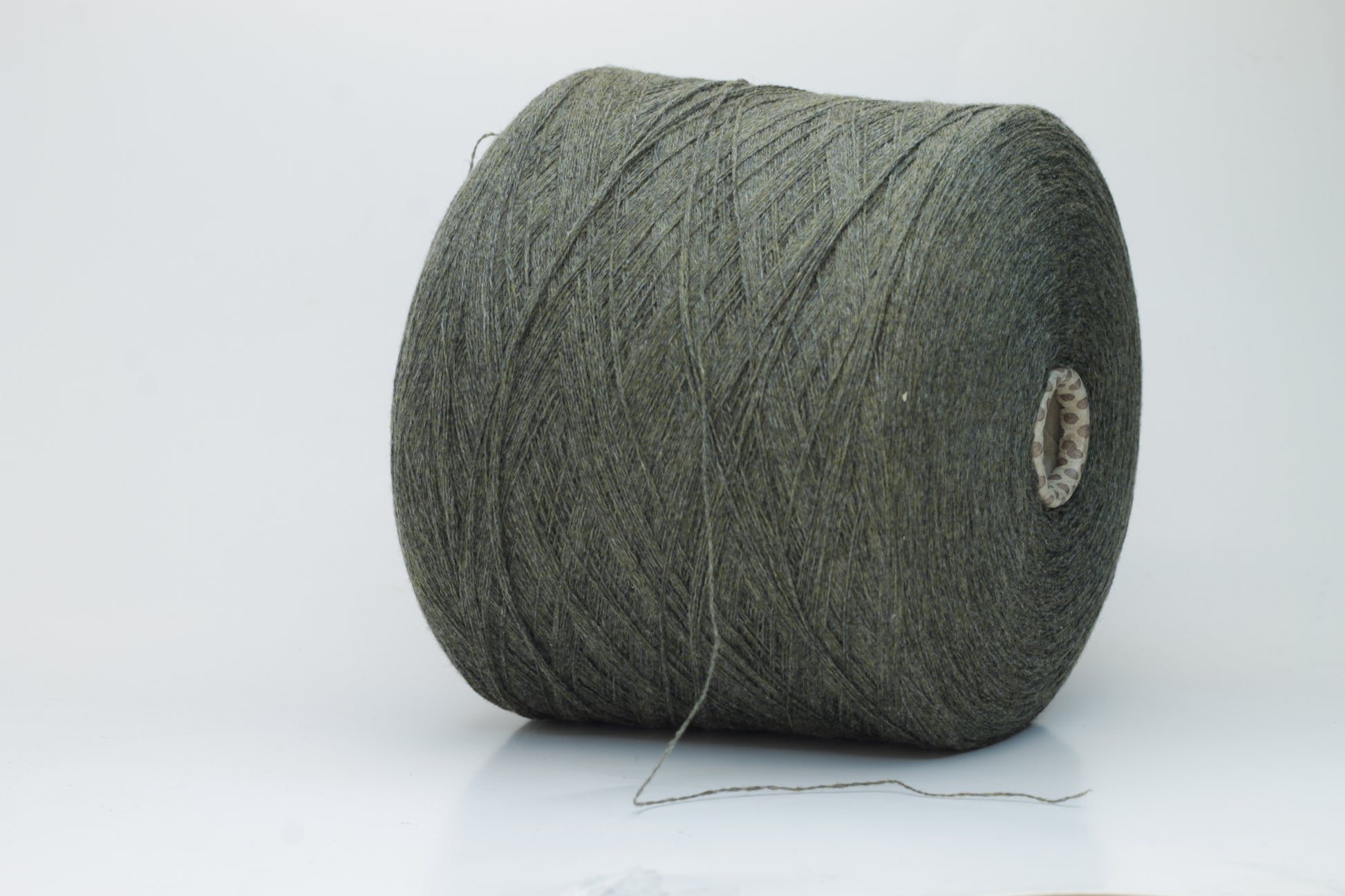 Close-up of a skein of luxurious 100% cashmere yarn in a deep Borneo brown, showcasing its soft, slightly matte sheen and subtle halo.
