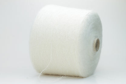 Close-up of fine white Kid Mohair and Silk yarn, exhibiting a soft, ethereal halo and subtle luminous sheen, gently twisted.