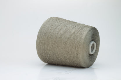 A skein of natural, undyed linen-polyamide yarn in an earthy beige. Features fine, even strands with a subtle organic texture and gentle luster.