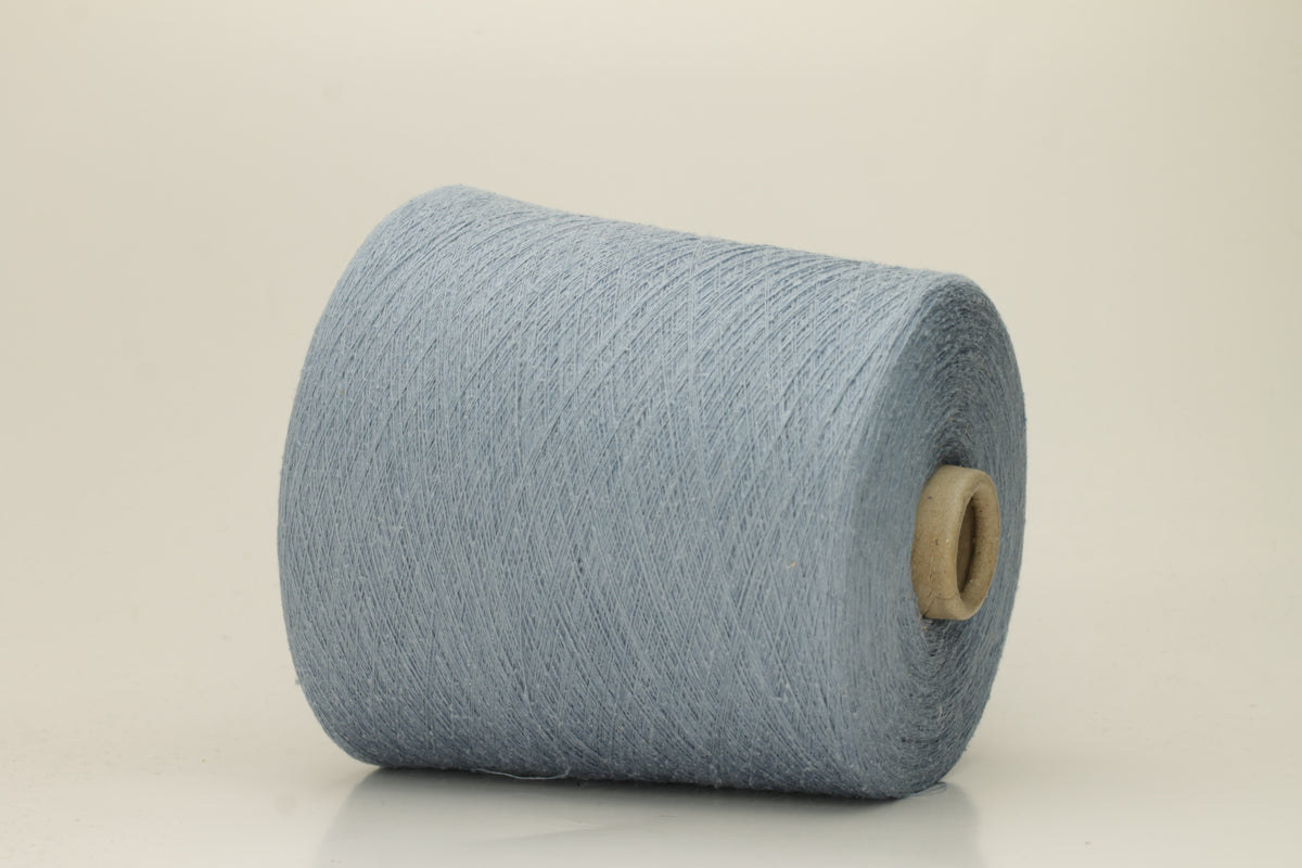 A tightly twisted single strand of luxurious deep royal blue silk yarn, reflecting light with a soft, natural sheen.