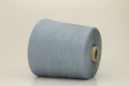 A tightly twisted single strand of luxurious deep royal blue silk yarn, reflecting light with a soft, natural sheen.