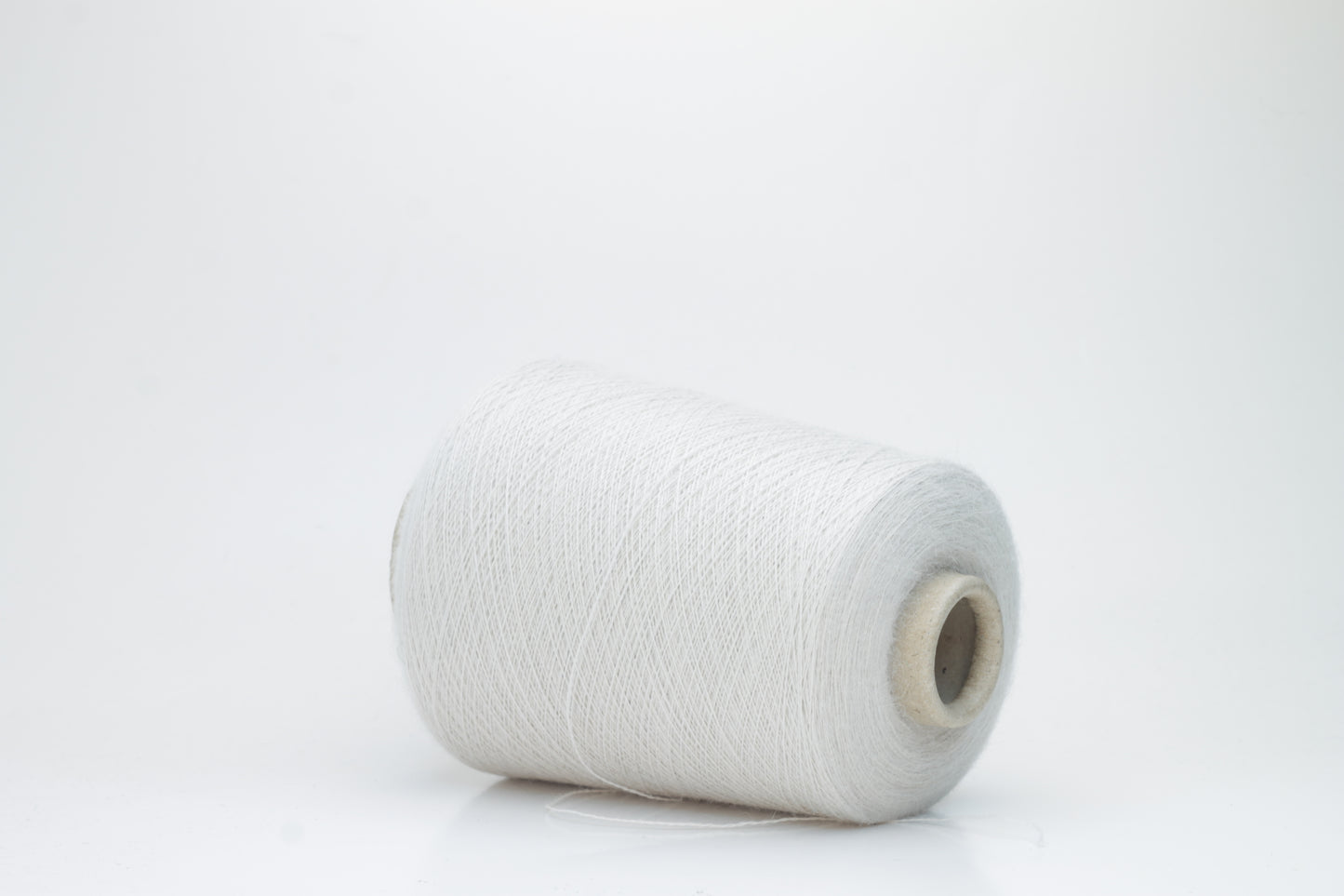 Close-up of lustrous beige 2-ply alpaca merino yarn, subtly twisted with a fine, even structure and soft, low halo.
