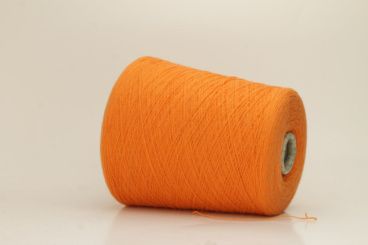 Close-up of fluffy, deeply saturated Jaffa orange cashmere yarn, showing its soft, slightly twisted two-ply structure and delicate sheen.