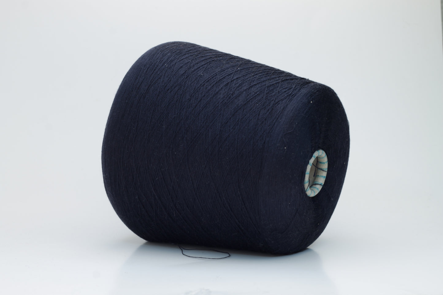 A gleaming skein of fine-gauge, two-ply silk yarn, deep rich dark navy hue, showcasing smooth texture & luxurious natural sheen.