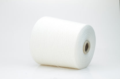 Close-up view of a creamy white, fluffy yarn strand with subtle sheen. The yarn shows a twisted ply construction and a dense, luxurious texture, hinting at its high cotton and cashmere fiber content.