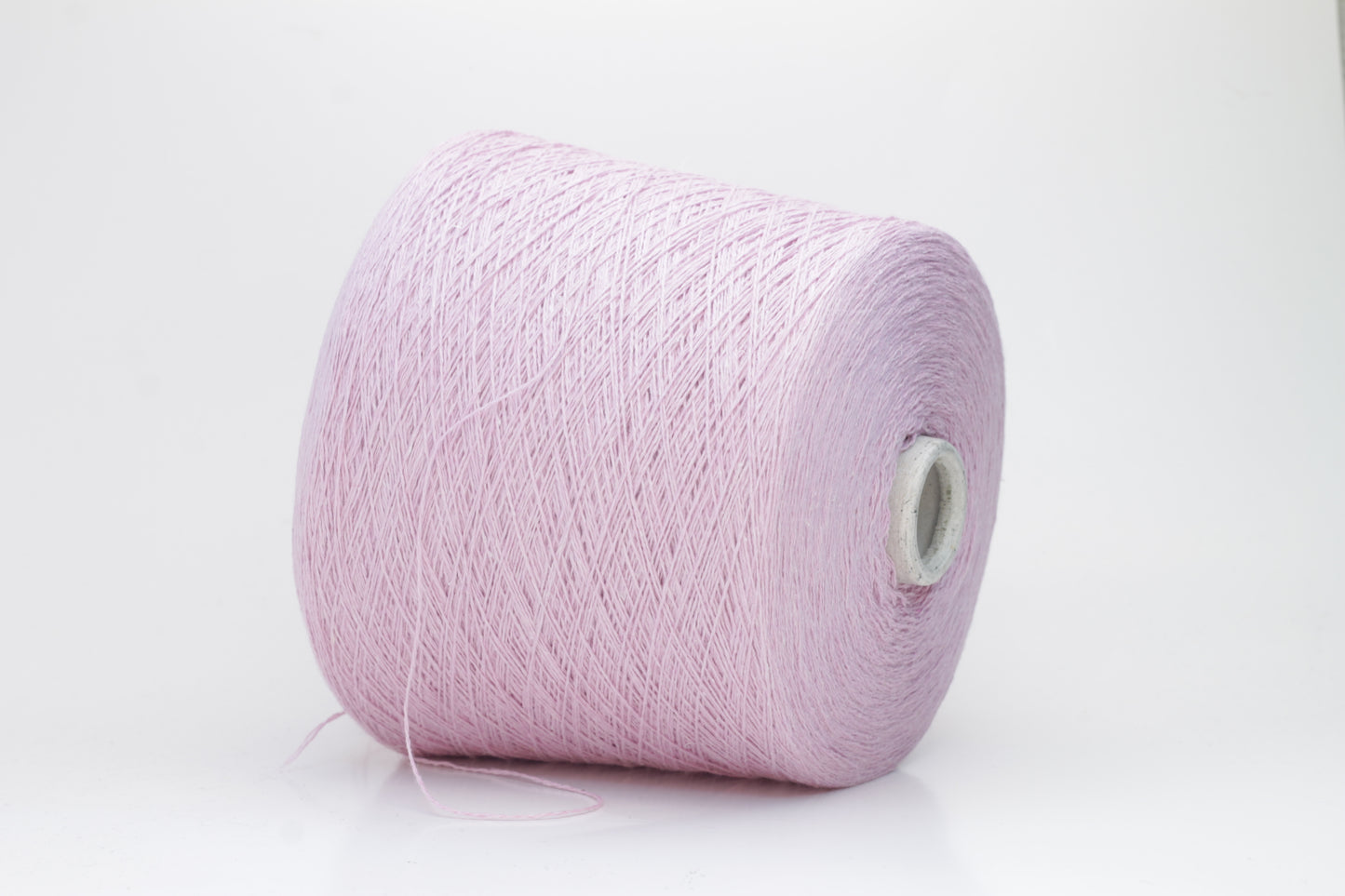 A soft, plump 2-ply yarn in a delicate antique rose hue, loosely coiled, exhibiting a subtle, silken sheen and slight halo. The fibers appear evenly spun.