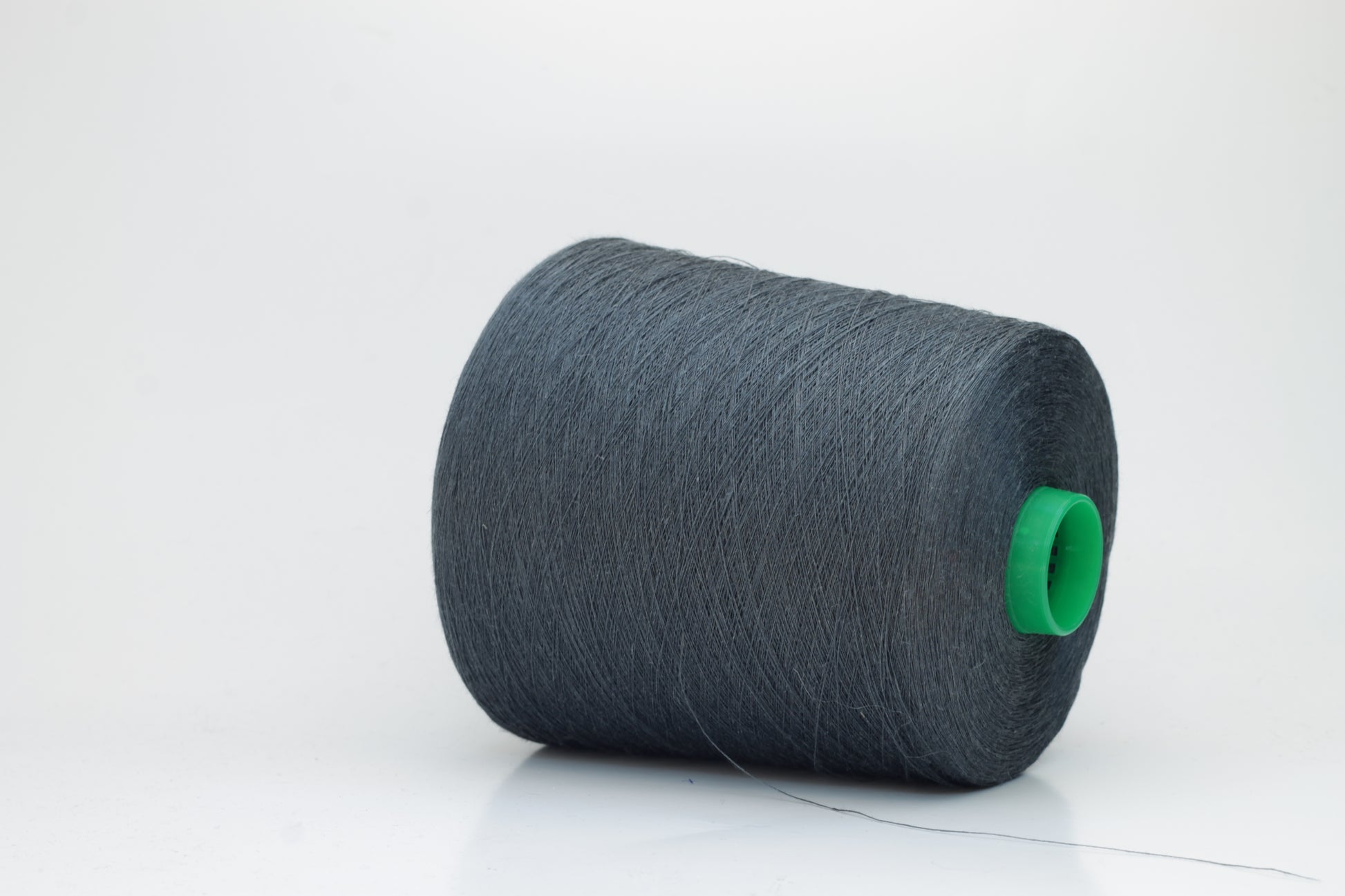 Fine, single-ply linen yarn in a rich Charcoal Grey. Reveals a crisp texture and subtle natural sheen, typical of pure linen fiber.