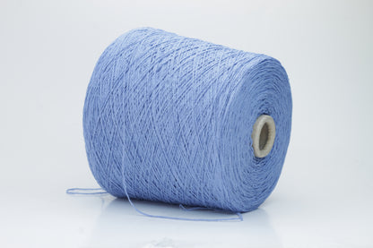 Close-up of a skein of deep Blue bourette silk yarn, showing its characteristic subtle slubs and matte texture, with a gentle, soft twist.