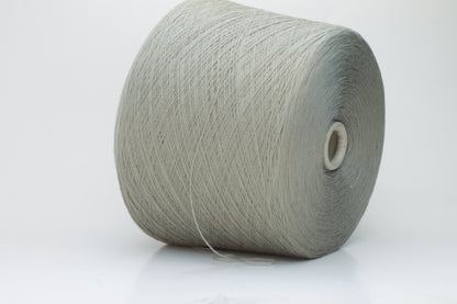 Close-up shot of the grey merino yarn, showcasing its fine 2/30 ply twist and subtle sheen, with a fluffy texture revealed through careful lighting.