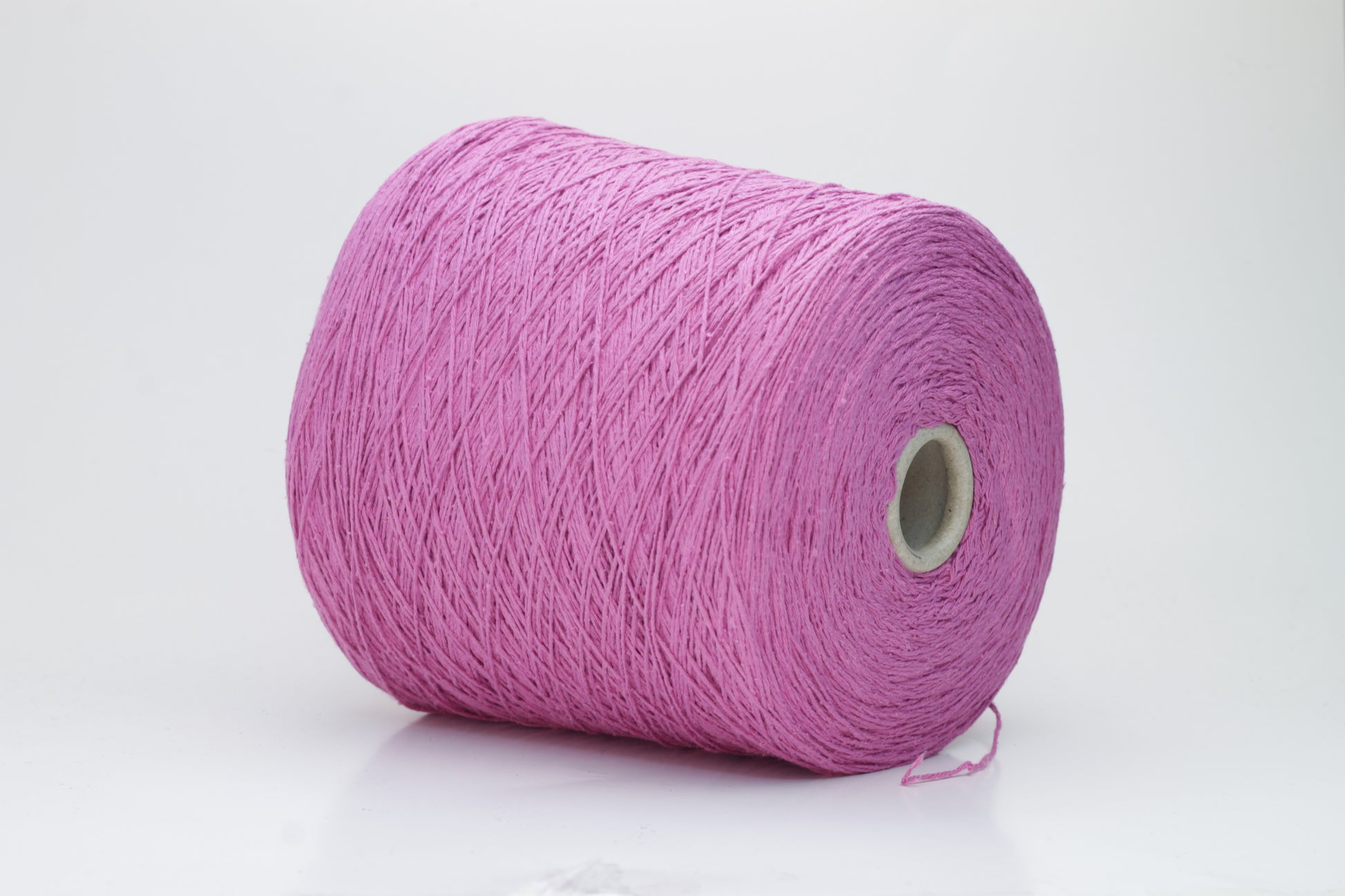 Close-up shot of the Rosa Fuxia Silk Bourette yarn, showcasing its shimmering, fluffy texture and tightly twisted ply structure. The silk fibers exhibit a subtle sheen with rich color depth.