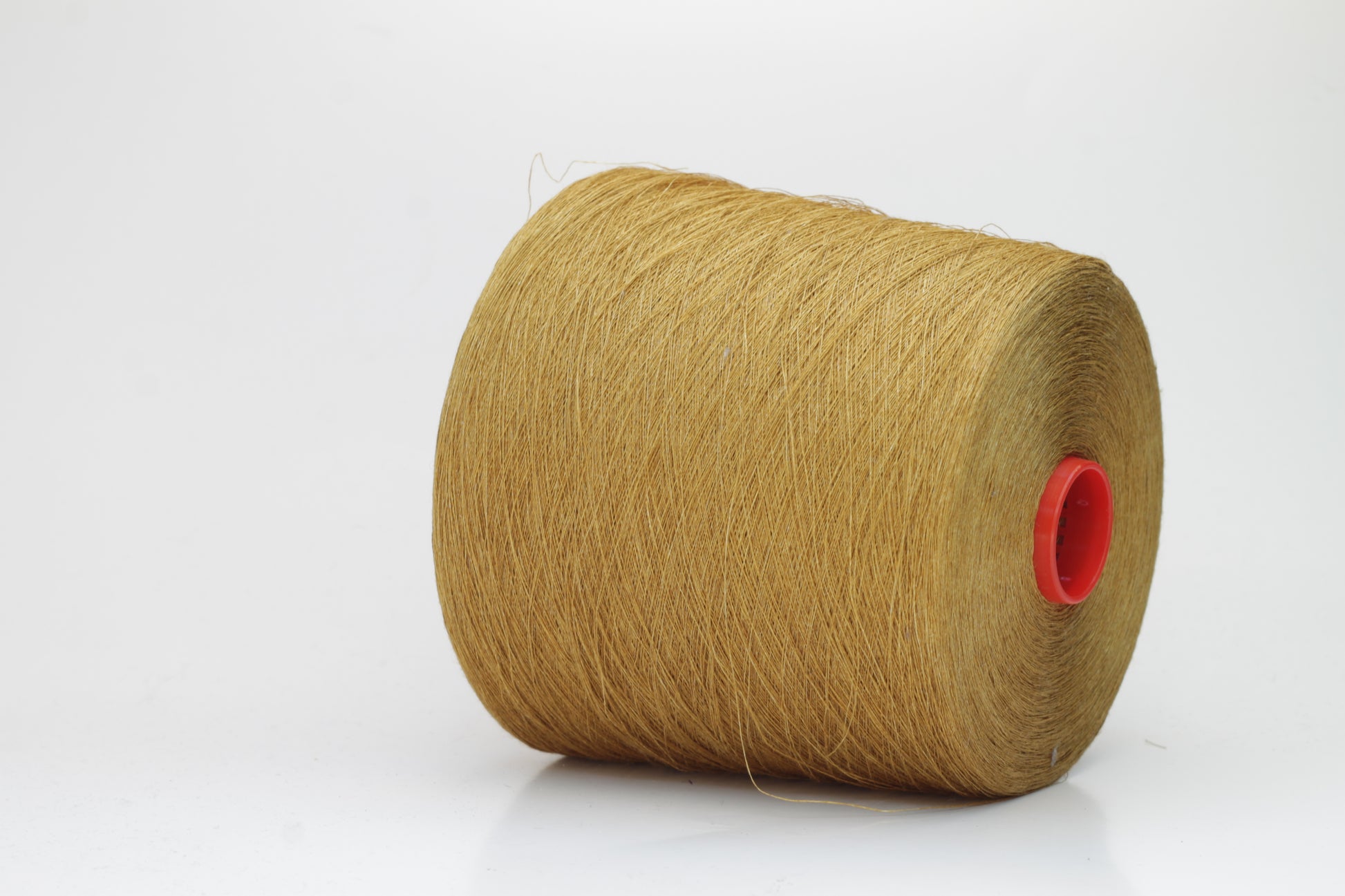Fine, single-ply linen yarn in a rich Muted Mustard. Reveals a crisp texture and subtle natural sheen, typical of pure linen fiber.