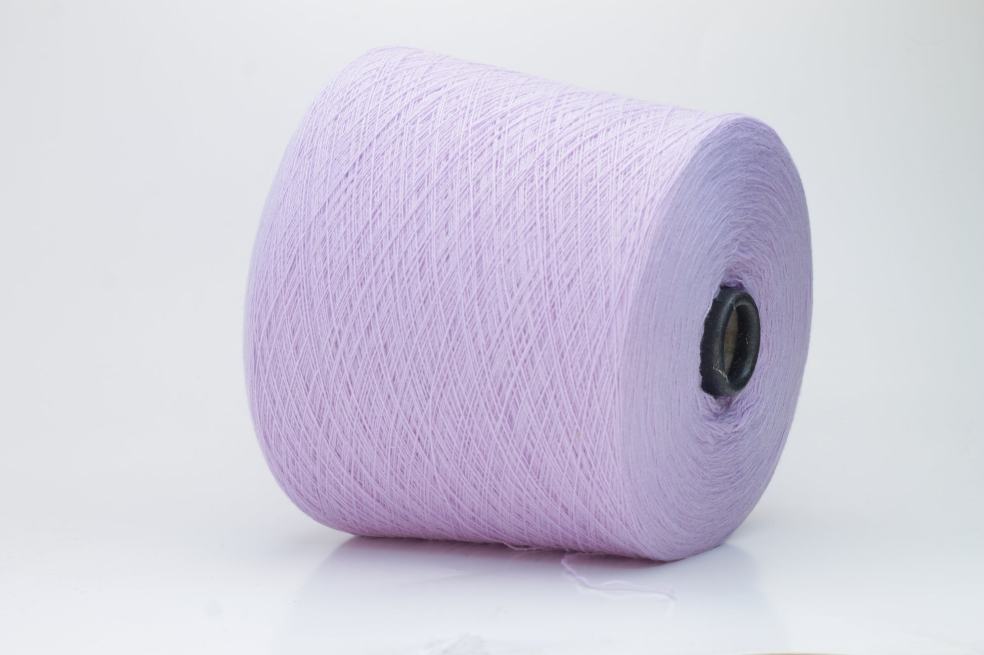 Close-up of soft, delicate two-ply cashmere yarn in a serene lavender hue, exhibiting a subtle halo and gentle sheen.