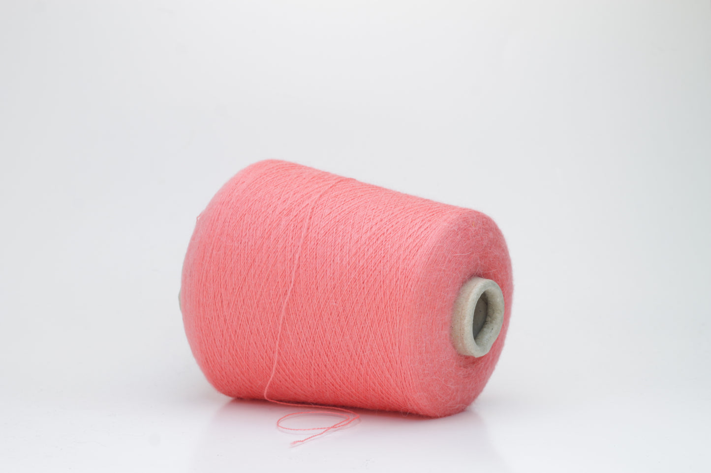 Coral 2-ply Alpaca Merino yarn, softly twisted with a gentle halo and subtle sheen, showcasing its deep, luxurious color saturation.