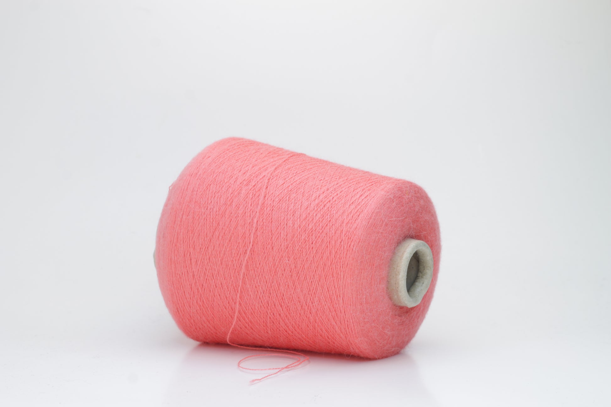 Coral 2-ply Alpaca Merino yarn, softly twisted with a gentle halo and subtle sheen, showcasing its deep, luxurious color saturation.