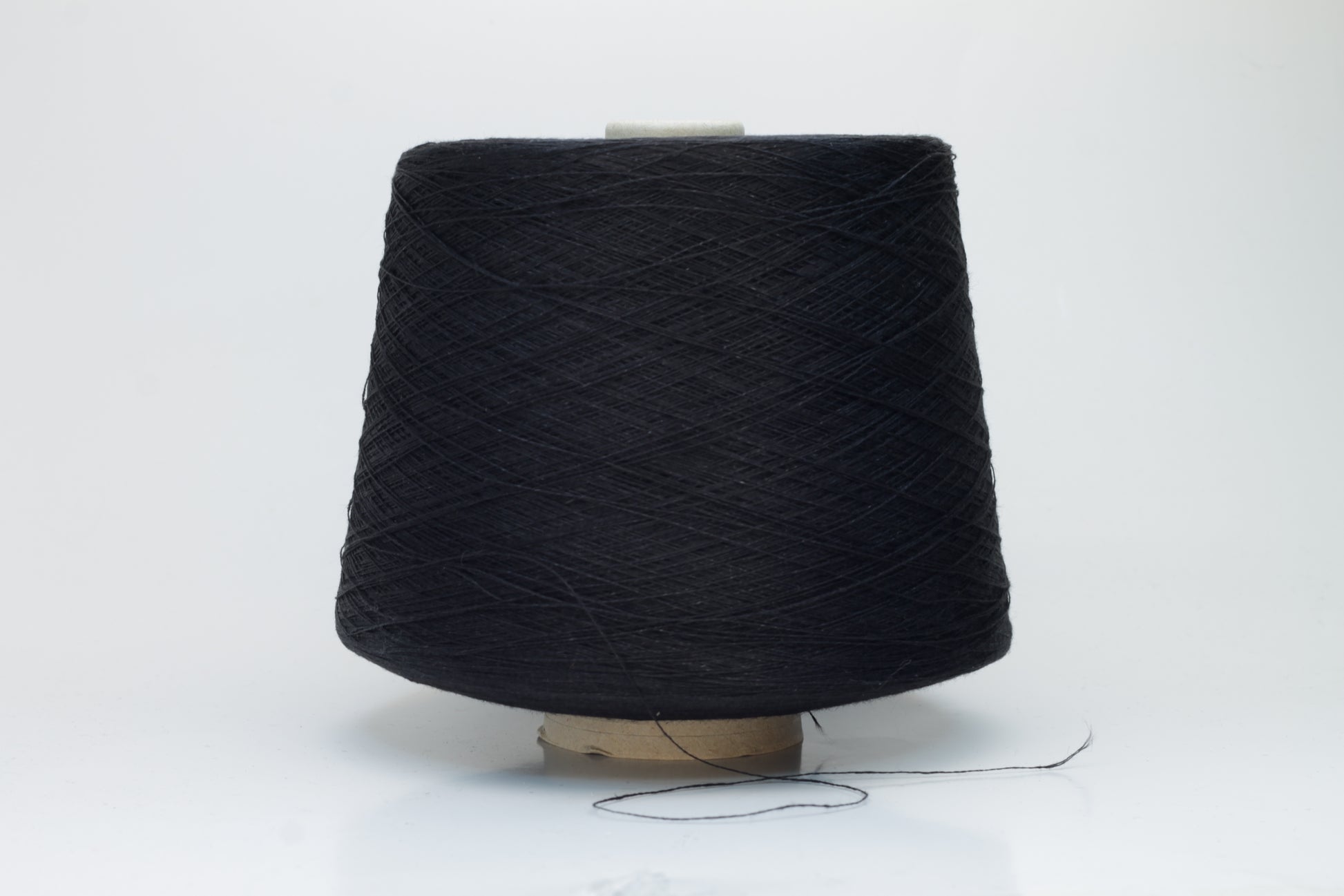 Finely spun Nm 2/26 linen yarn in a rich, deep ardesia slate gray, showcasing a smooth, uniform twist and subtle natural sheen.