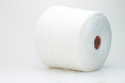 Close-up of pristine white, finely plied 100% cashmere yarn, showcasing its soft halo and subtle sheen on a neutral background.