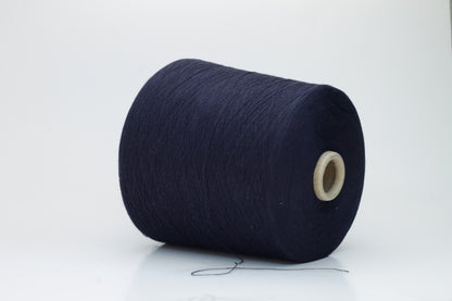 Close-up shot of dark blue, fluffy cotton 85% cashmere 15% yarn in a twisted ply, showcasing the fine thread structure and subtle sheen.