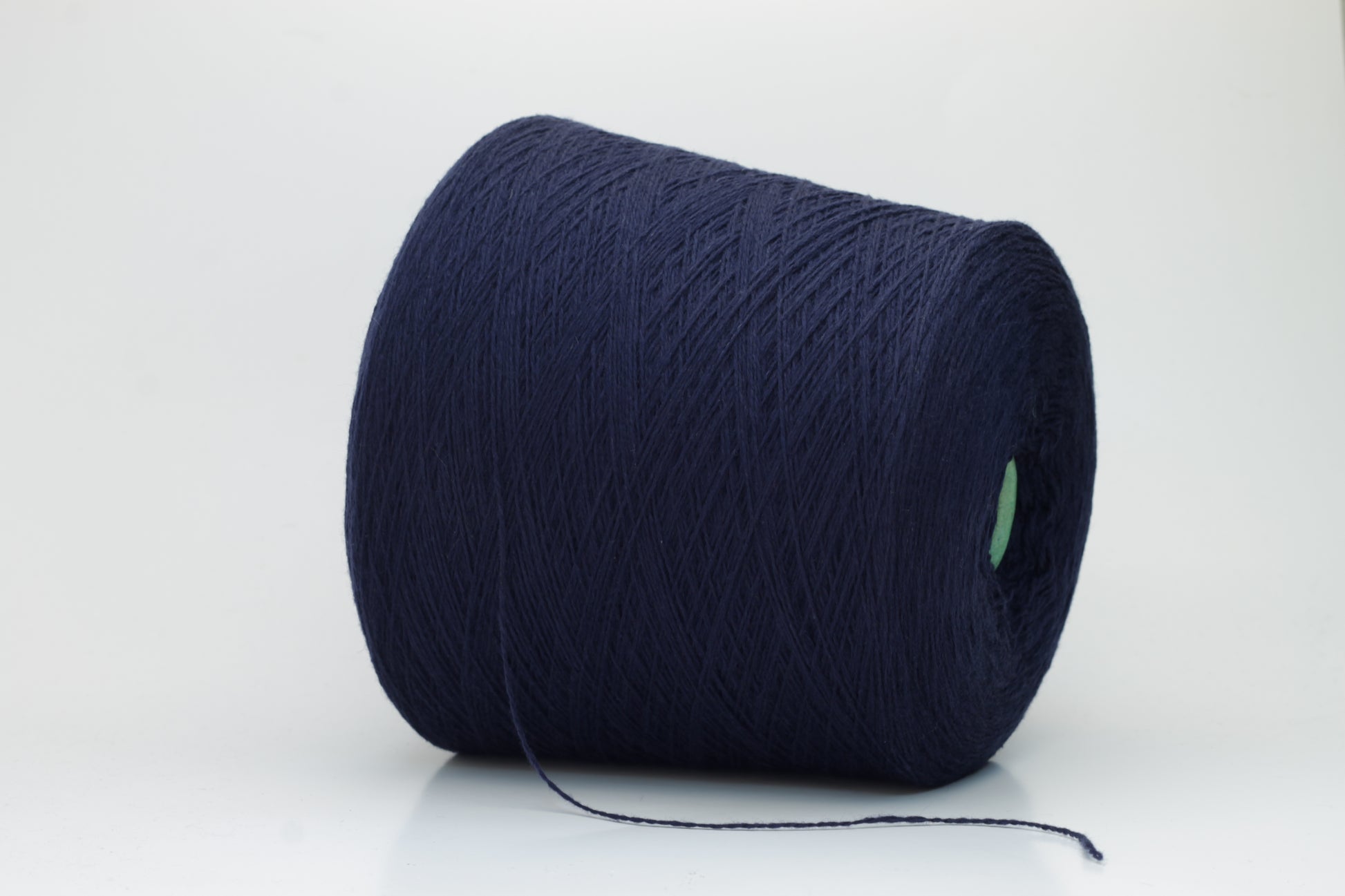 Luxurious Navy cashmere yarn, two-ply twist with a subtle sheen, displaying deep, consistent color and a fine, soft texture ready for crafting.