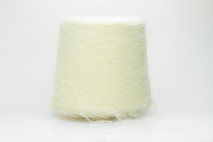 Close-up shot of SuperKidMohair yarn in Light Yellow, revealing a lustrous, fluffy texture with subtle sheen and a tight, well-defined ply twist.