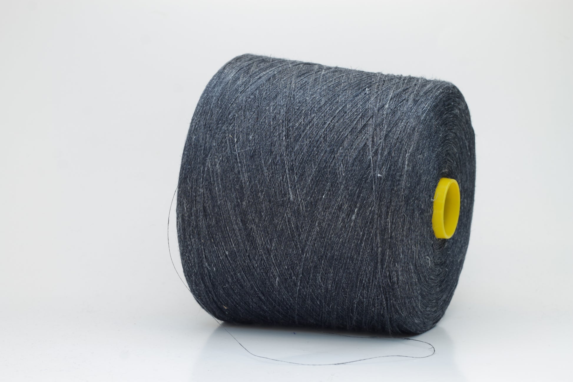 Fine, single-ply linen yarn in a rich Storm Gray. Reveals a crisp texture and subtle natural sheen, typical of pure linen fiber.