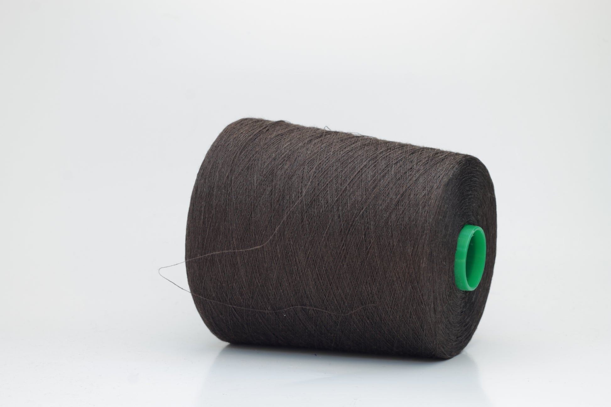 Fine, single-ply linen yarn in a rich Brown. Reveals a crisp texture and subtle natural sheen, typical of pure linen fiber.