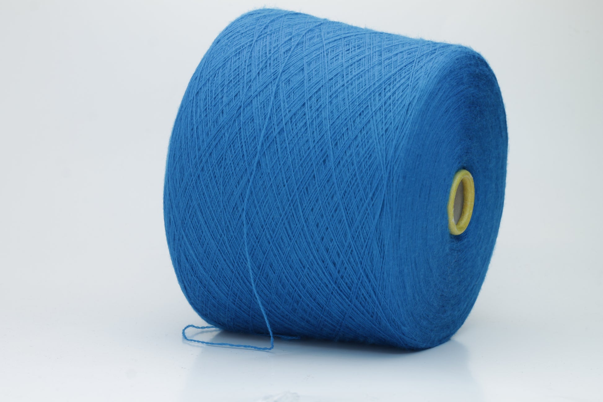 Close-up view of Zegna Baruffa Merino 100% Cashwool yarn in a deep blue hue, showcasing the twisted ply structure and subtle sheen with a fluffy texture.