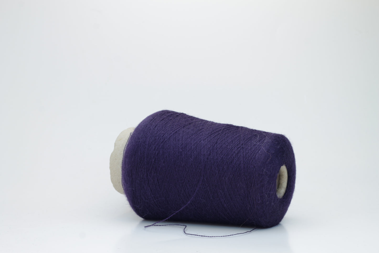 Rich purple 2-ply Alpaca Merino yarn, softly twisted with a gentle halo and subtle sheen, showcasing its deep, luxurious color saturation.