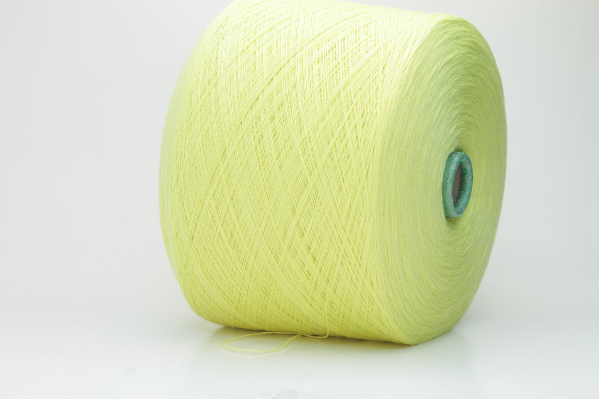 Close-up shot of a skein of ZEGNA Baruffa Merino 100% Cashwool yarn in Lemon color. The yarn exhibits a tight, twisted ply structure with a subtle sheen and a fluffy, inviting texture.