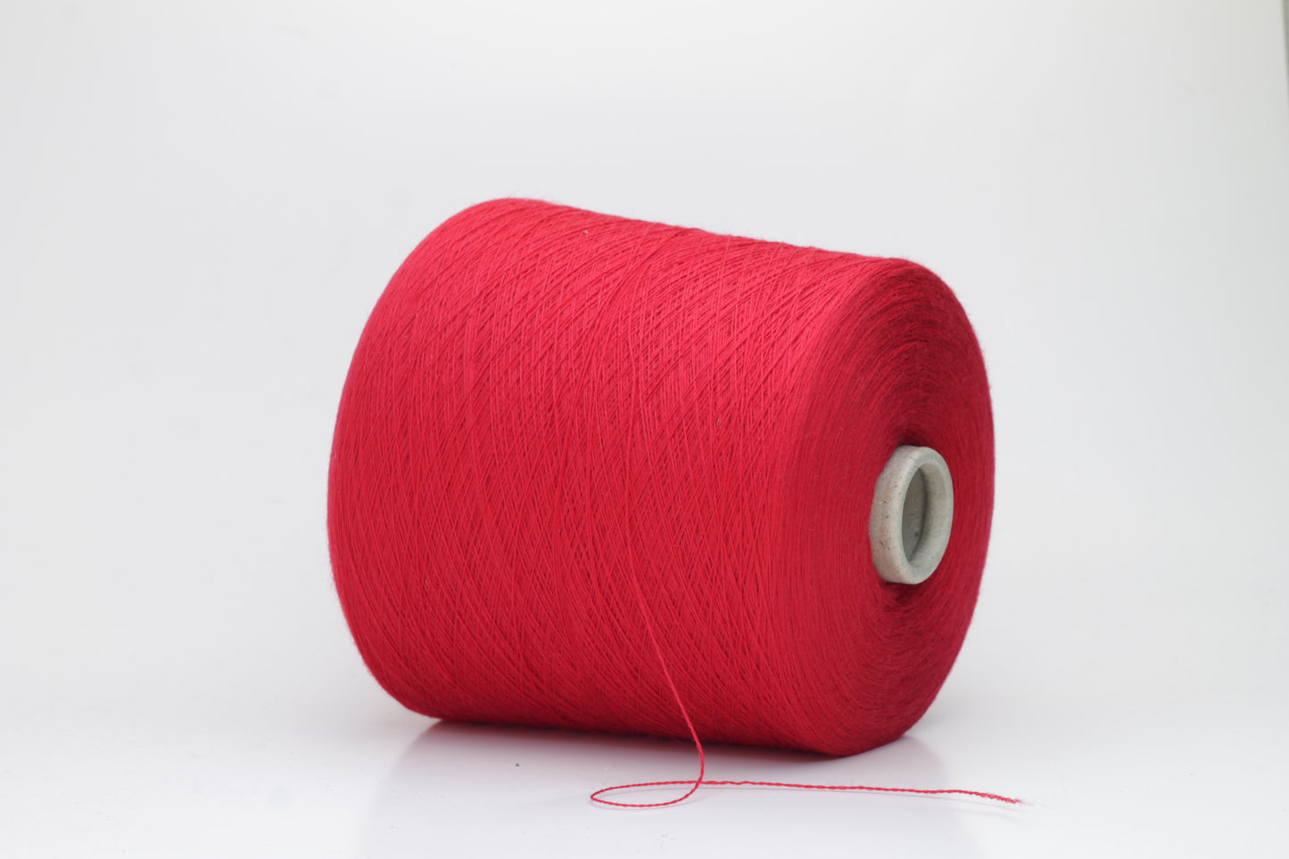 Close-up of luxurious Red Merino wool yarn, two-ply twist with a soft, subtle sheen, and fine, consistent thread structure.