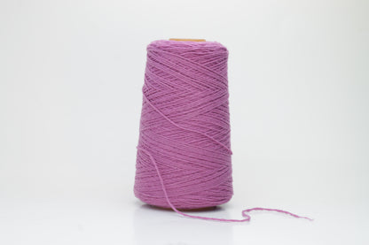 A beautifully wound cone of fine, single-ply cashmere yarn in a soft wisteria purple hue, displaying a delicate halo of fluff and subtle sheen.