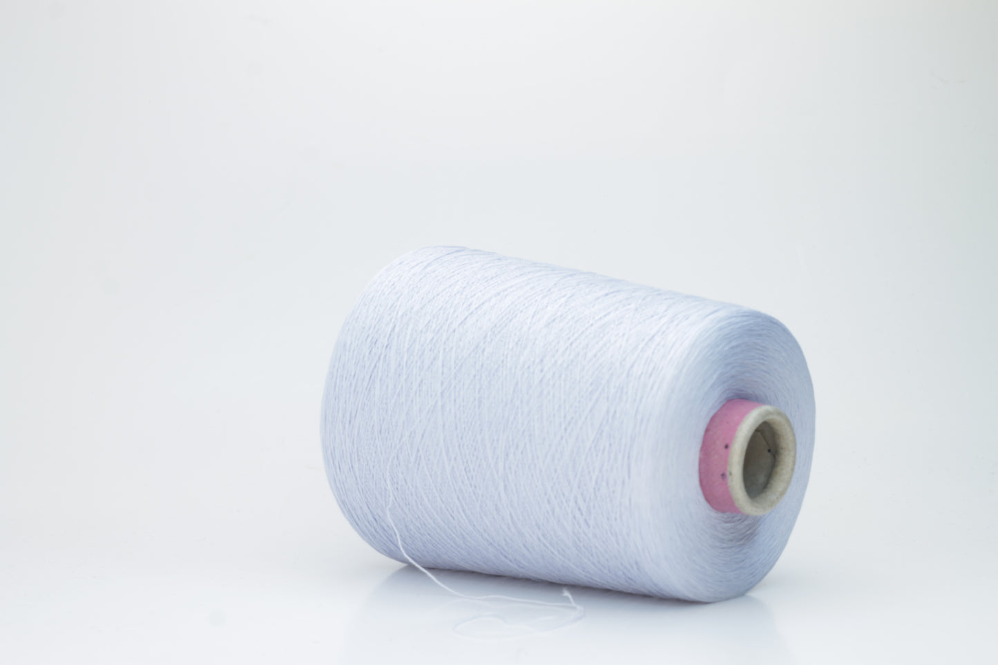 Close-up shot of light blue mulberry silk and viscose yarn, showing a tight, even ply twist with subtle sheen and fluffy texture.