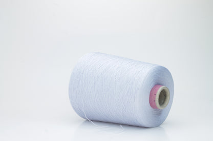 Close-up shot of light blue mulberry silk and viscose yarn, showing a tight, even ply twist with subtle sheen and fluffy texture.