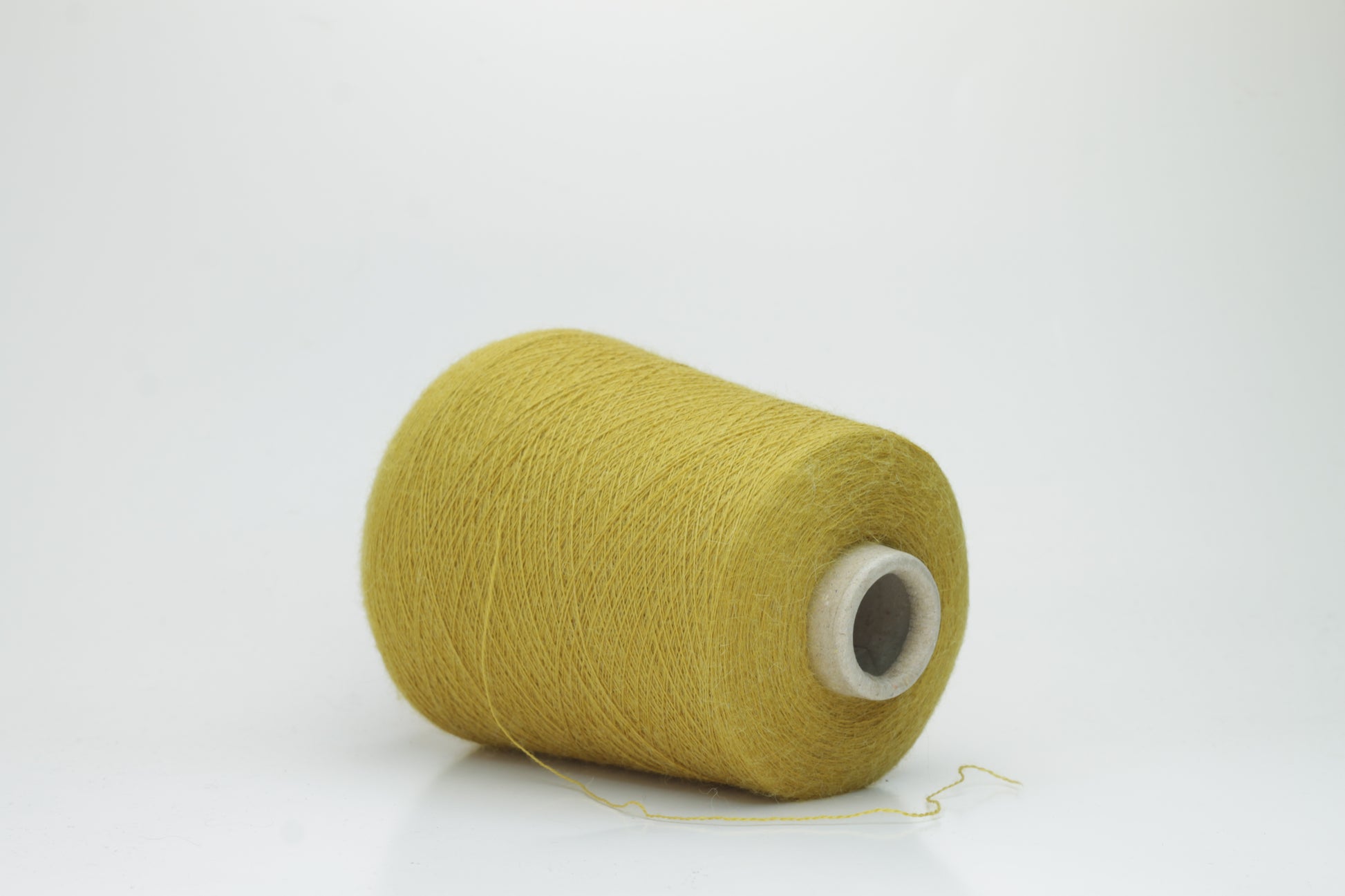 Mustard 2-ply Alpaca Merino yarn, softly twisted with a gentle halo and subtle sheen, showcasing its deep, luxurious color saturation.