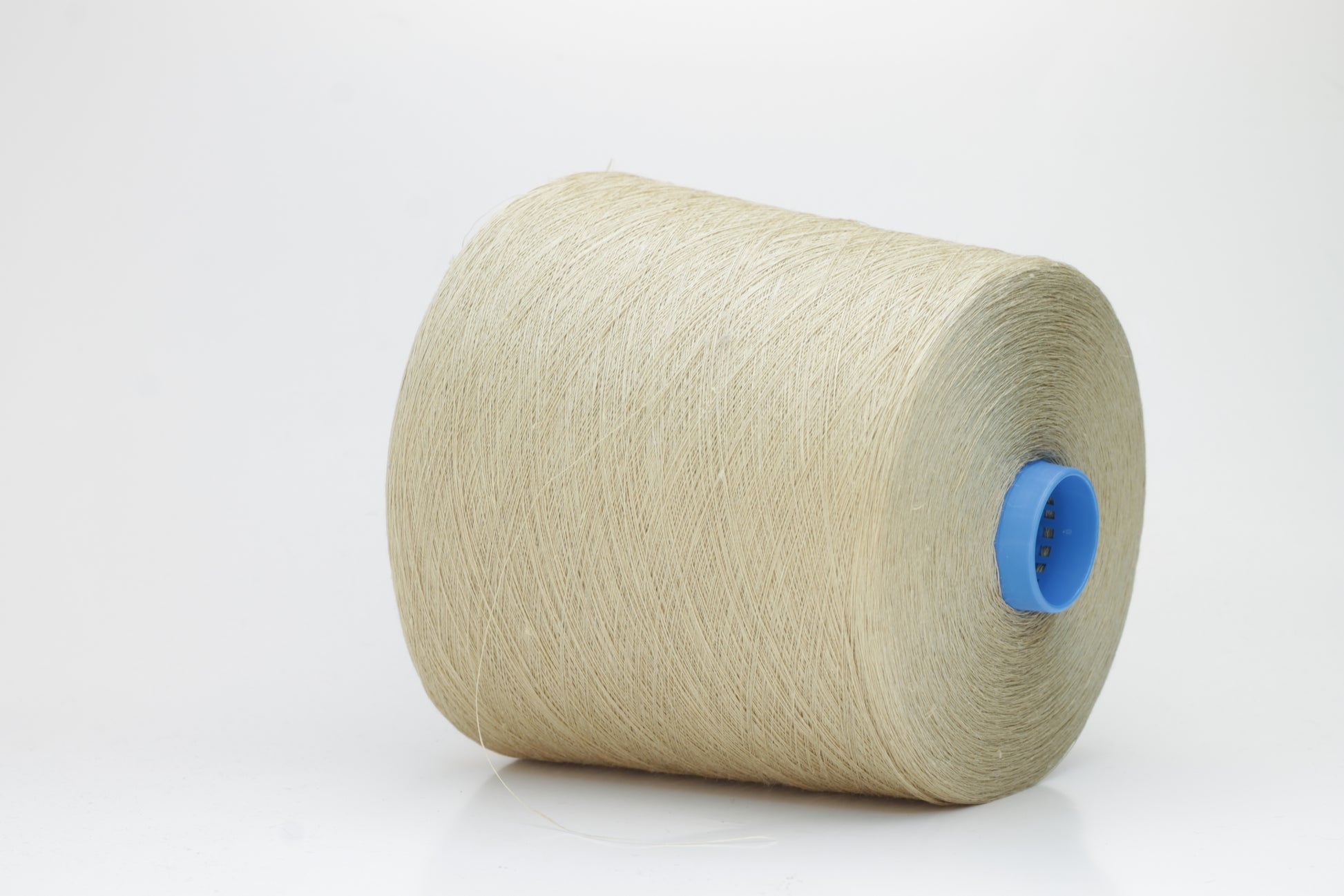 Fine, single-ply linen yarn in a rich Oatmeal. Reveals a crisp texture and subtle natural sheen, typical of pure linen fiber.