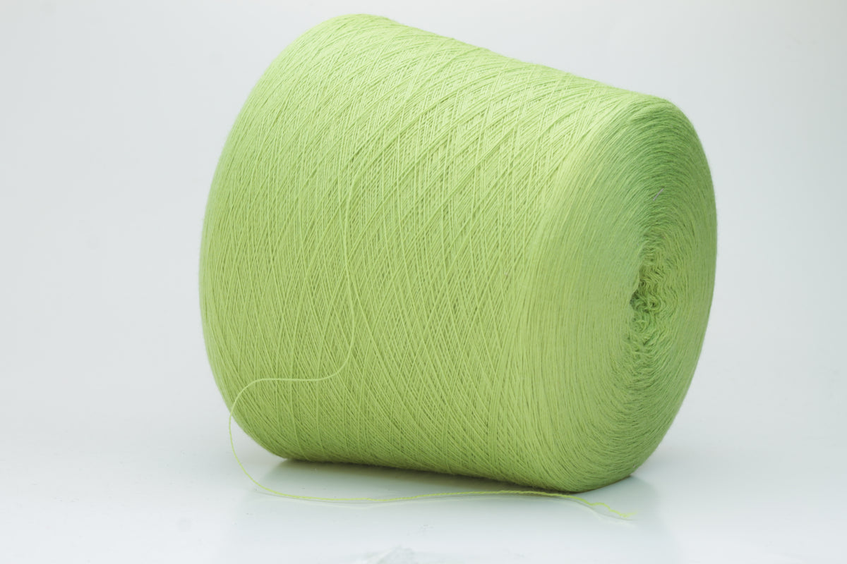 Close-up shot of the '100% Merino Toolegno 1900 Nm 2/30 Green Premium Yarn', showcasing the fluffy green fibers and a prominent ply twist, highlighting the dense thread structure and subtle sheen.