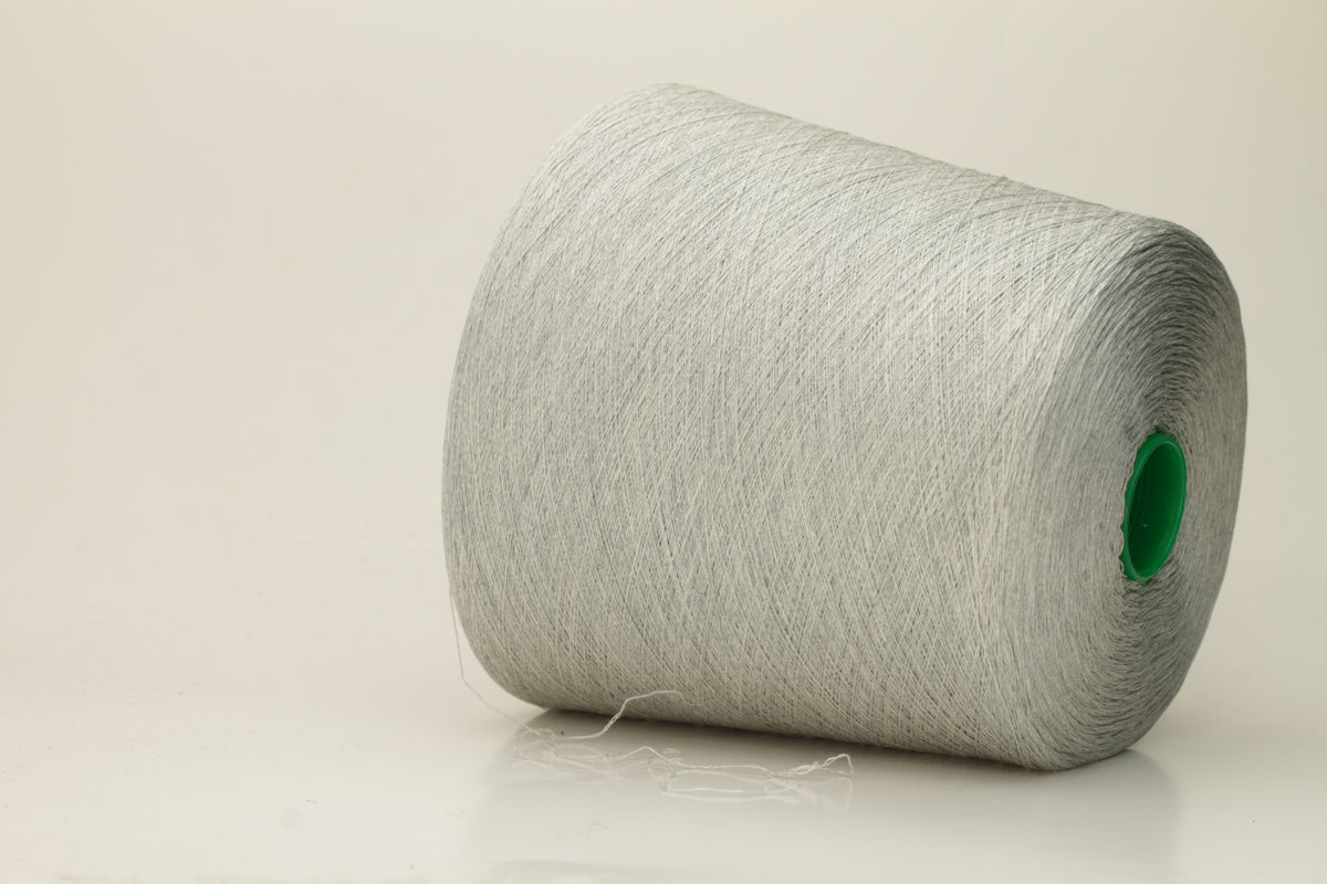 Close-up of a smooth, tightly plied gray yarn skein with a subtle, refined sheen, showcasing the luxurious blend of silk and cotton fibers.