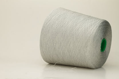 Close-up of a smooth, tightly plied gray yarn skein with a subtle, refined sheen, showcasing the luxurious blend of silk and cotton fibers.