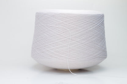 Close-up of soft, light pink Zegna Baruffa merino wool yarn with a fine ply twist, showcasing the dense thread structure and subtle sheen.