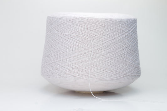Close-up of soft, light pink Zegna Baruffa merino wool yarn with a fine ply twist, showcasing the dense thread structure and subtle sheen.