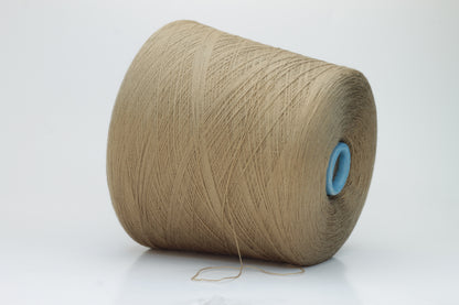 Close-up shot of a cone of creamy camel colored 100% merino yarn, showcasing the fine ply twist and subtle sheen of the fibers.