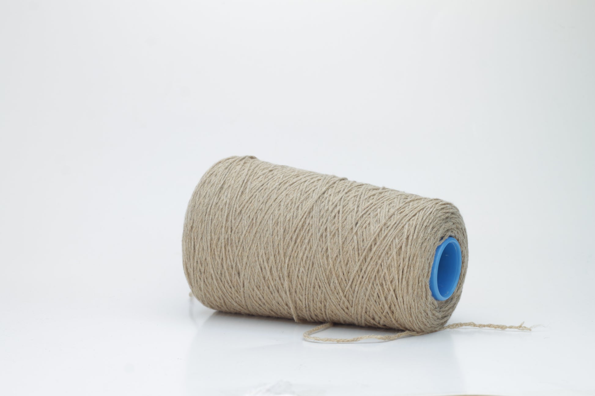 A skein of finely spun single-ply cashmere yarn in a delicate, muted grey-pink 'Polvere' shade, showcasing its inherent soft fluffiness and subtle, natural sheen.