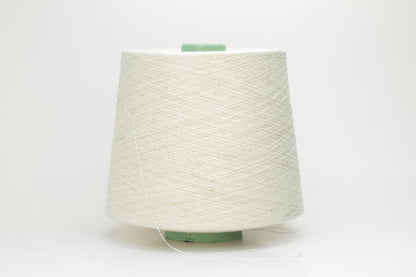 Close-up of a skein of soft, pure white bourette silk yarn with characteristic subtle slubs and a matte, natural finish.