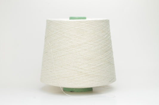 Close-up of a skein of soft, pure white bourette silk yarn with characteristic subtle slubs and a matte, natural finish.