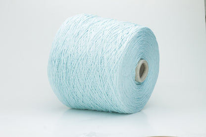 Close-up of fine, natural Linuzzo-colored 100% linen yarn, showing its smooth, slightly matte texture and subtle ply twist, coiled loosely.