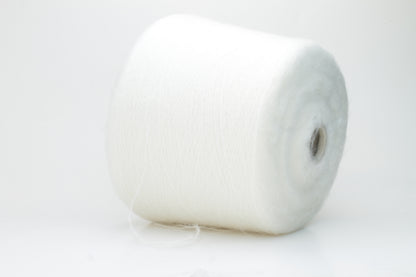 Close-up view of SuperKidMohair yarn in Aurora White color, showcasing its fluffy texture and subtle sheen. The yarn exhibits a smooth ply twist with a rich color depth.