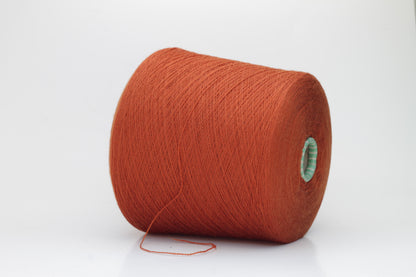 Close-up of luxurious Terra Cotta Merino wool yarn, two-ply twist with a soft, subtle sheen, and fine, consistent thread structure.