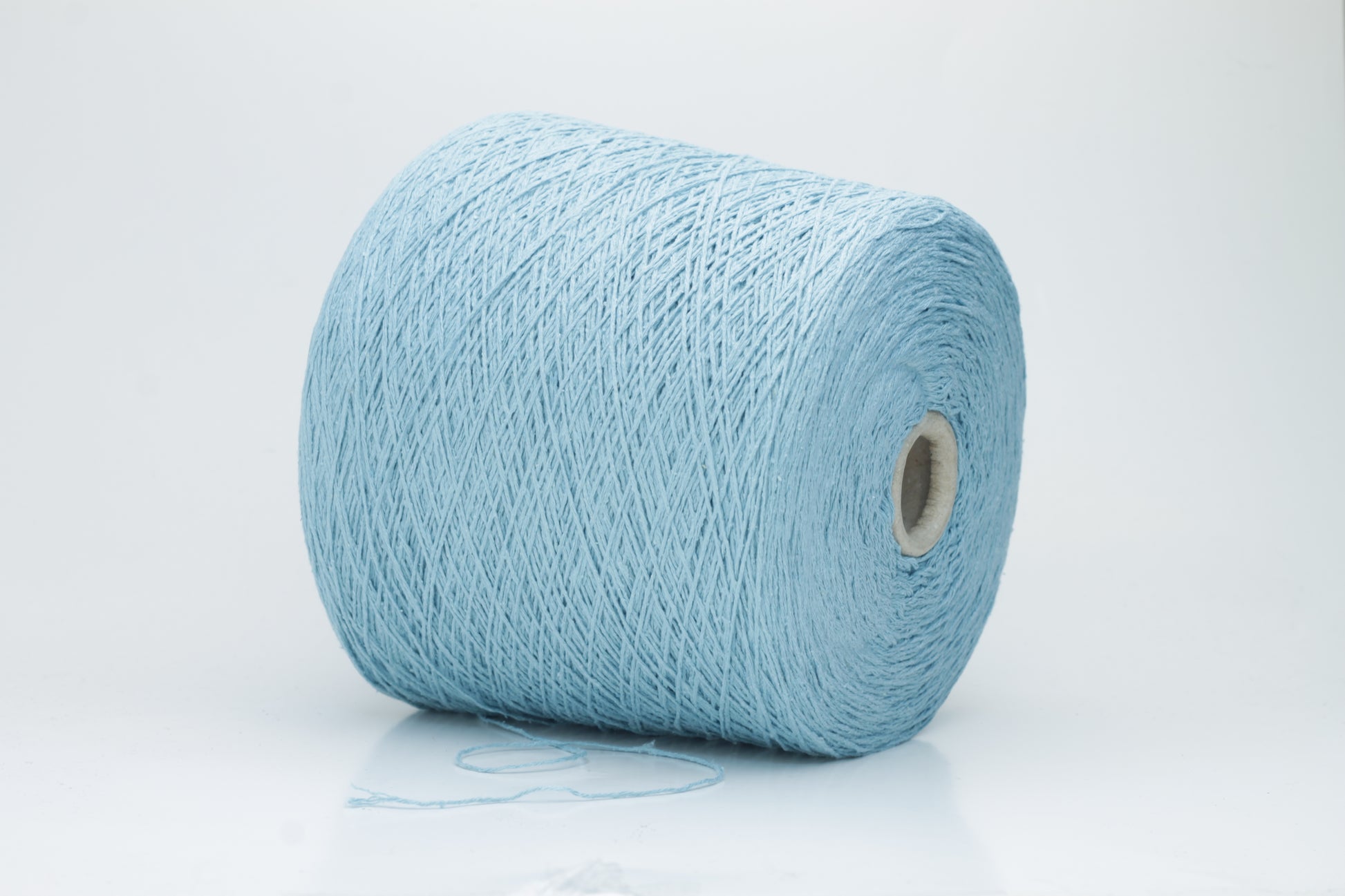 Close-up shot showcasing the shimmering, fluffy texture of the Coscata Silk Bourette yarn, with visible ply twists and a subtle sheen, highlighting its luxurious feel.