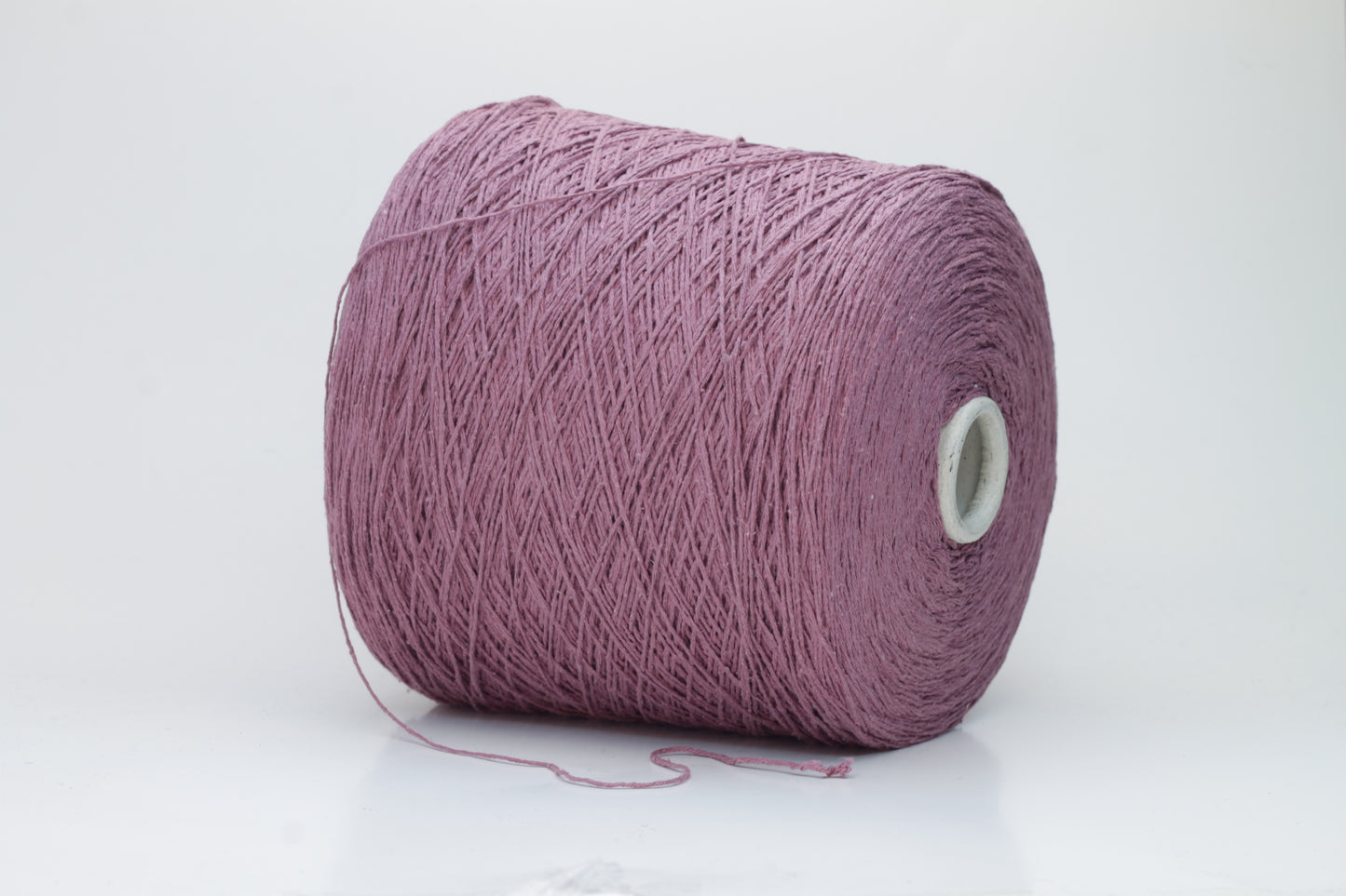 Close-up image of the burgundy silk bourette yarn, showcasing a dense ply twist and subtle sheen. The yarn appears incredibly soft and fluffy with rich color depth.